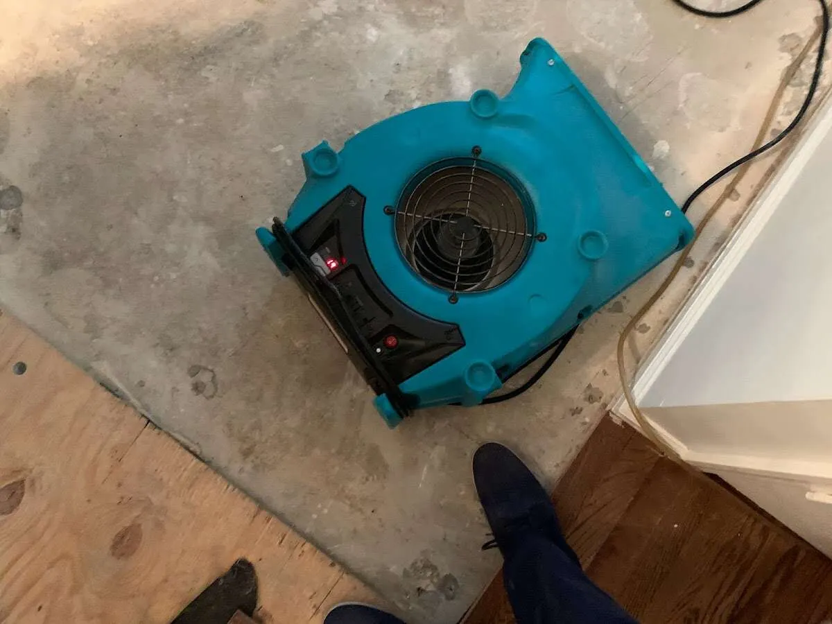 Air mover drying subfloor during Commercial Water Damage Restoration in Mansfield